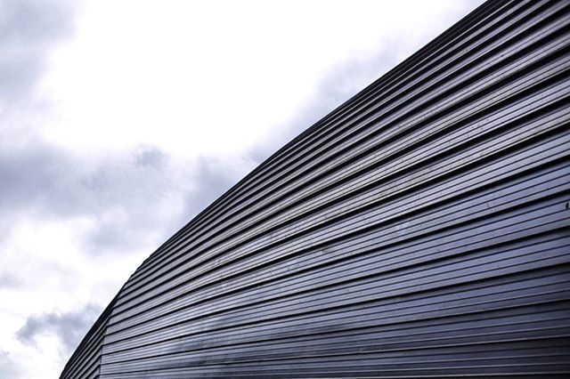 low angle view, sky, cloud - sky, cloudy, cloud, pattern, built structure, day, outdoors, no people, repetition, in a row, architecture, building exterior, nature, backgrounds, modern, full frame, overcast, high section