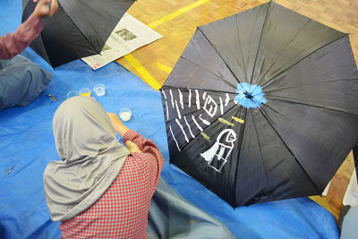 Low section of woman sitting on floor