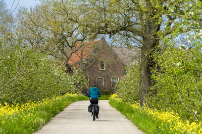 Rear view of woman walking on field