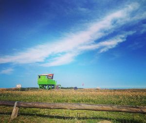 Scenic view of agricultural field against blue sky