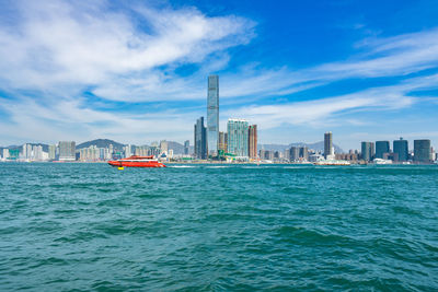 Scenic view of sea and buildings against sky