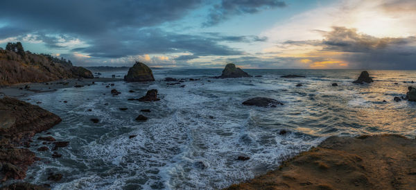 Scenic view of beach against sky during sunset