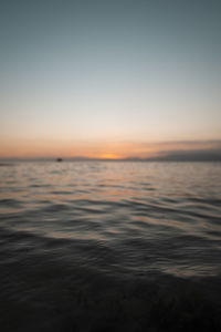 Scenic view of sea against clear sky at sunset