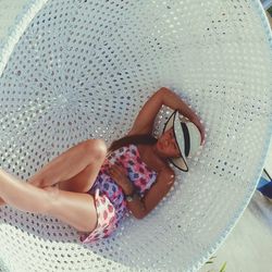 High angle view of woman lying down in sunglasses