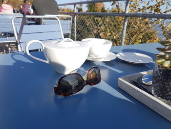 High angle view of glasses on table by swimming pool