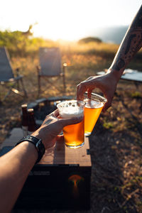 Cropped hand of woman holding drink