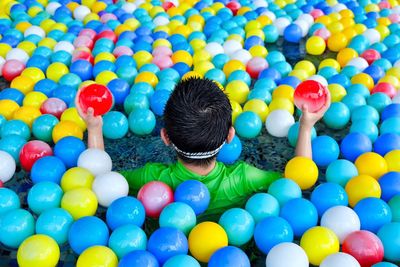 High angle view of multi colored balls in swimming pool