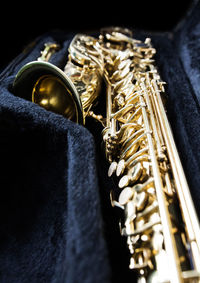 Close-up of golden musical equipment in box