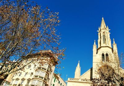 Low angle view of bell tower against blue sky