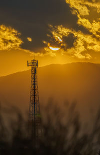 Silhouette tower against sky during sunset