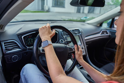 Midsection of man driving car