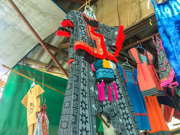 Low angle view of lanterns hanging by building