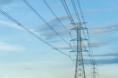 Low angle view of electricity pylon against sky