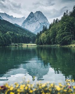 Scenic view of lake and mountains against sky