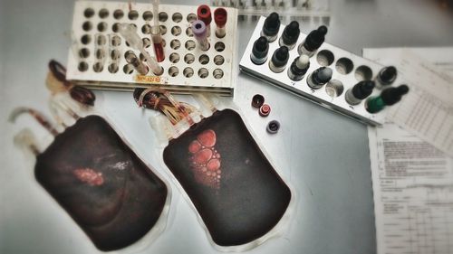 High angle view of blood bags with samples on table in hospital