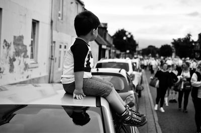 Girl holding toy while sitting on floor