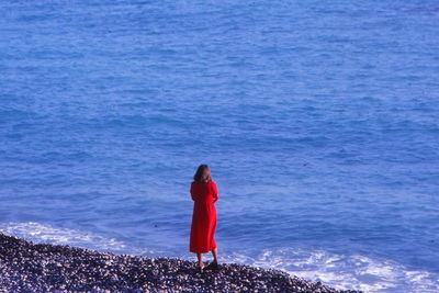 Rear view of woman standing in sea