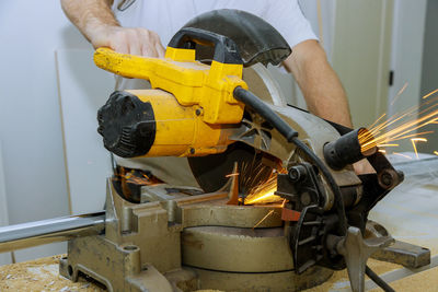 Midsection of man working in factory