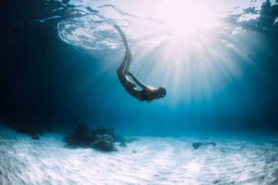 Low angle view of man swimming in sea