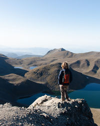 Man standing on mountain against sky