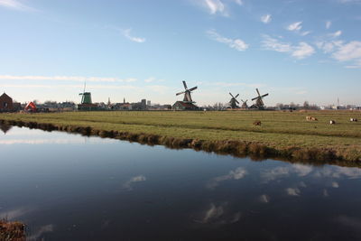 Traditional windmill on field against sky