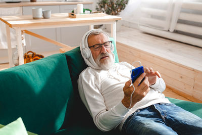 Senior man listening music at home