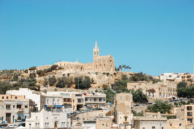 View of buildings against blue sky