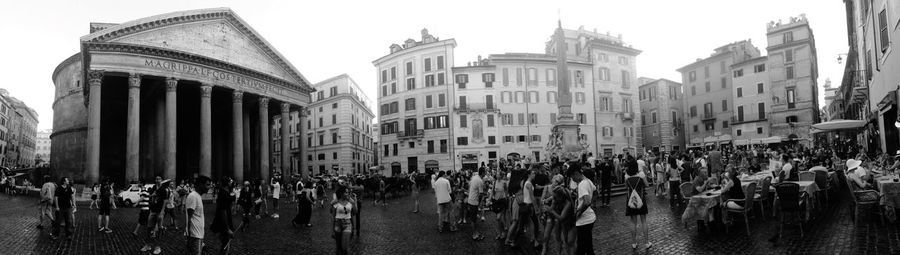 Group of people in front of buildings
