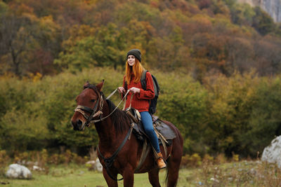 Young woman riding horse