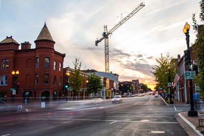 View of city street and buildings against sky