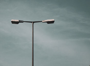 Low angle view of street light against sky