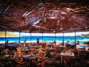 People on restaurant table by sea