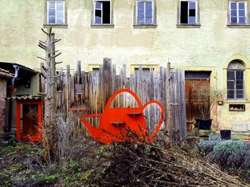 Abandoned building by street in city