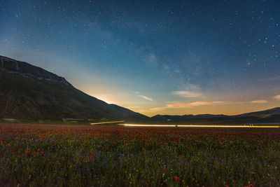 Scenic view of landscape against sky at dusk