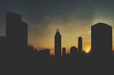 Silhouette built structures at sunset