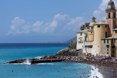 Buildings at sea shore against sky in camogli