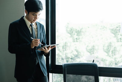 Portrait of businessman using digital tablet