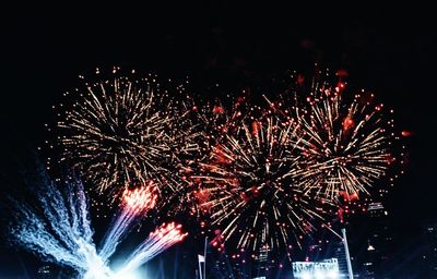 Low angle view of firework display at night