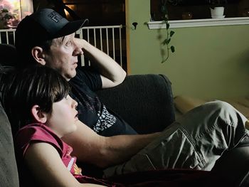 Portrait of senior man sitting on sofa at home
