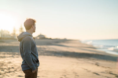 Side view of man standing on beach