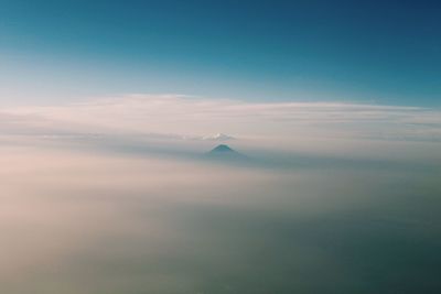 Aerial view of clouds over mountain