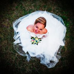 High angle portrait of smiling young woman on field