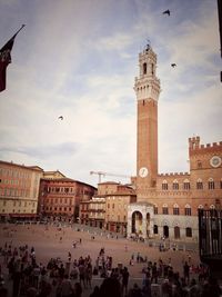 People on street by tower