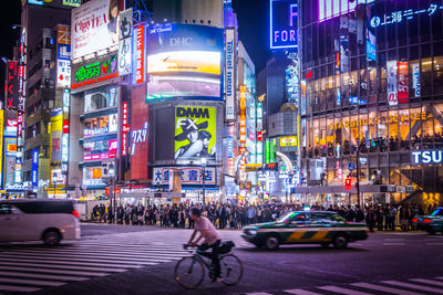 Illuminated commercial signs on buildings at shibuya