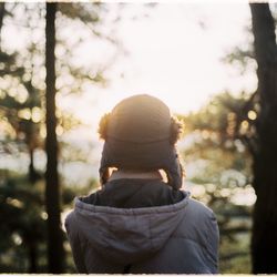 Rear view of woman in forest during winter