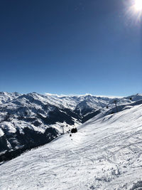 Scenic view of snowcapped mountains against clear sky