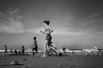 FULL LENGTH OF A WOMAN JUMPING IN SKY