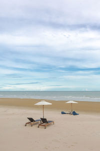 Long beach chairs with umbrella beach with the sand