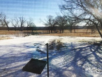 Snow on field against sky during winter