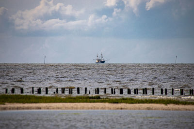 Ship sailing in sea against sky